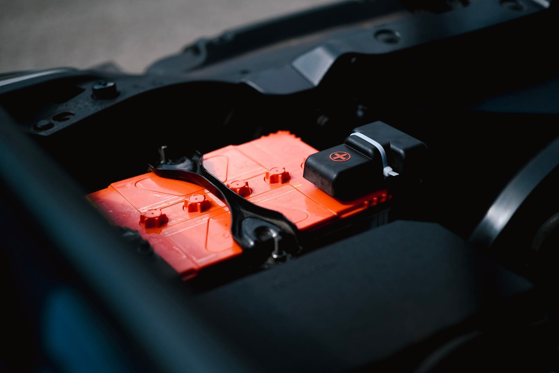 A car battery under the hood in winter