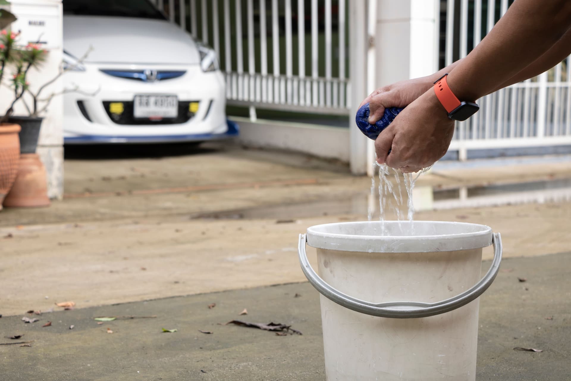 A car being washed with a microfiber mitt