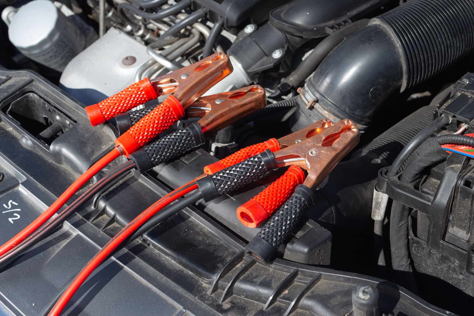 Battery clamps beside a car engine