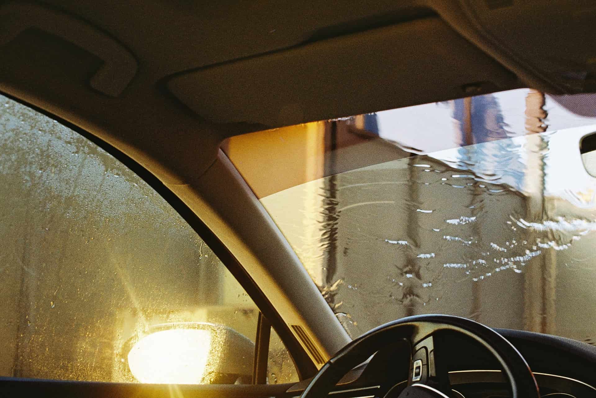 A wet car windshield seen through the glass