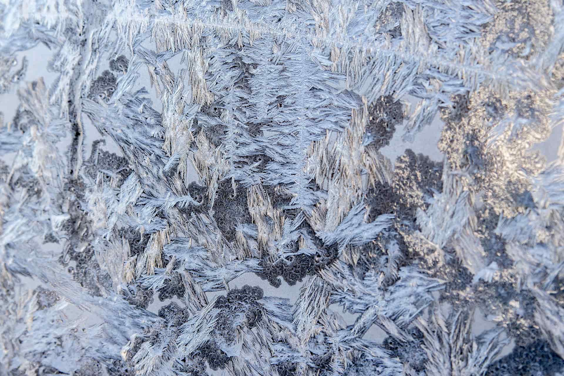 Frost crystals forming across a car window