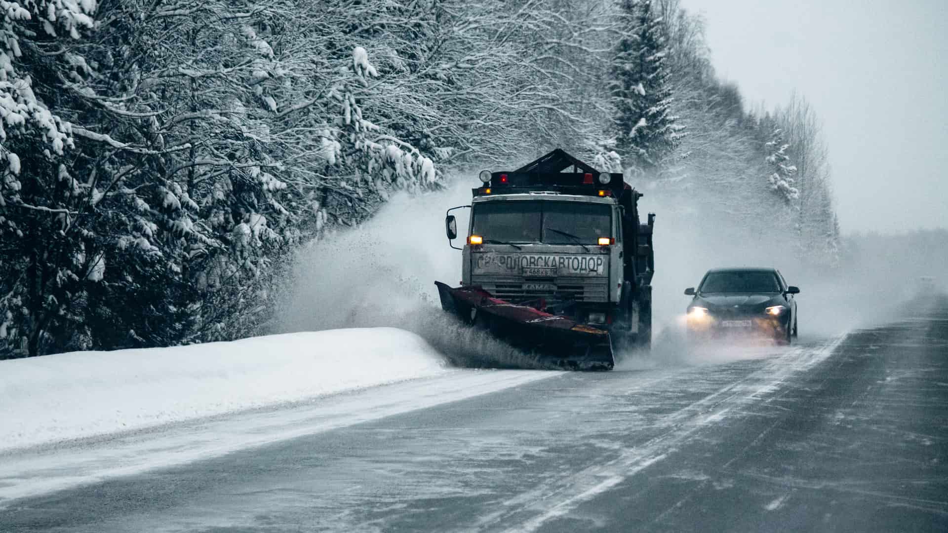 A winter road being cleared of snow