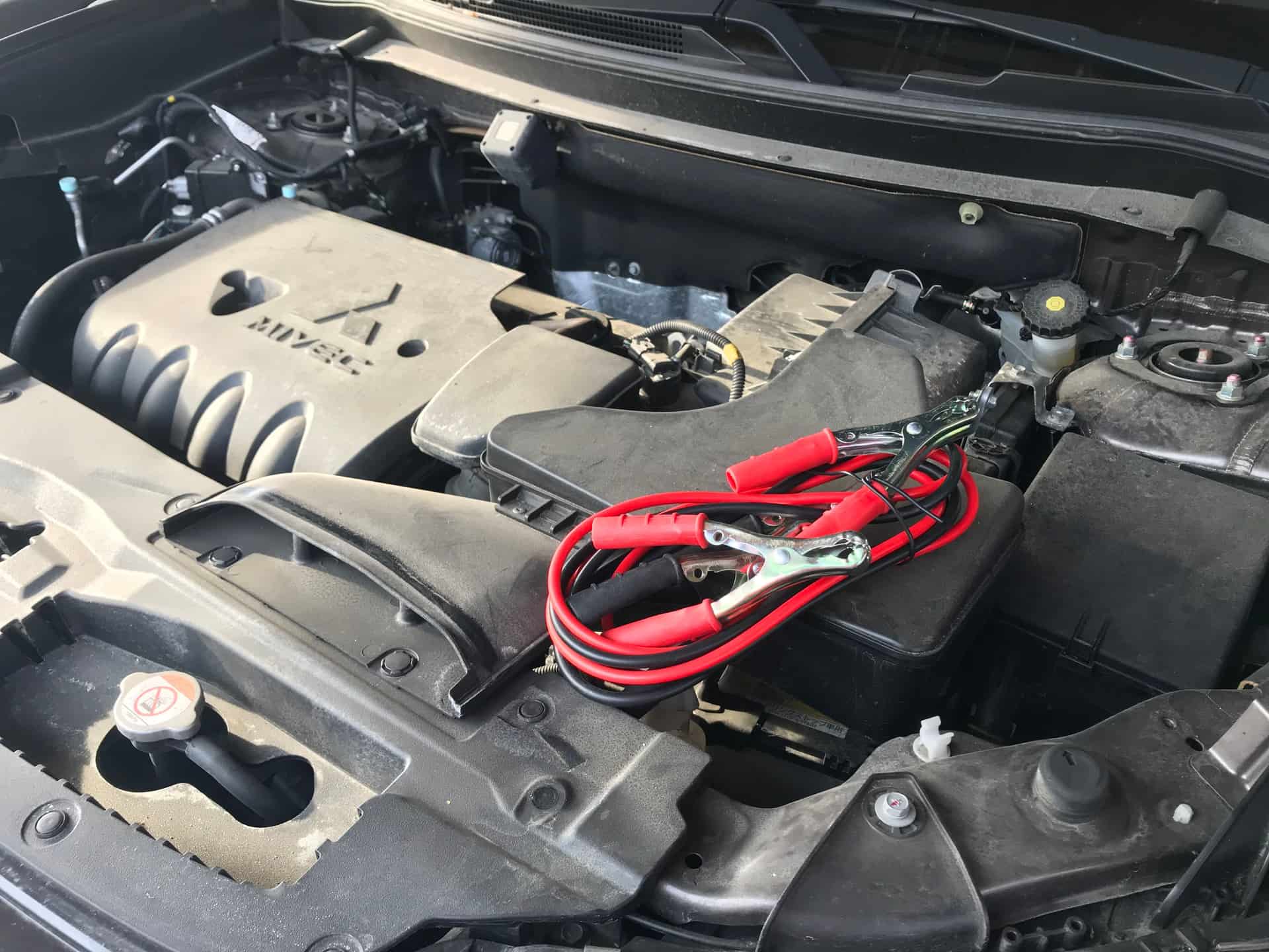 A car engine bay photographed in cold weather