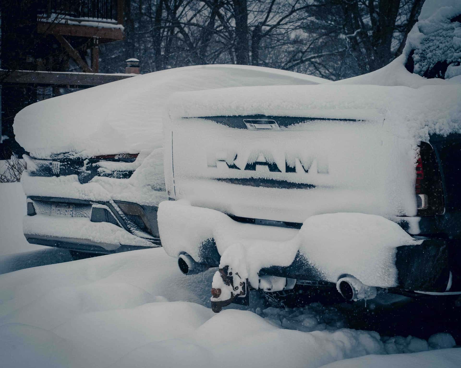 A pickup truck covered in snow during winter