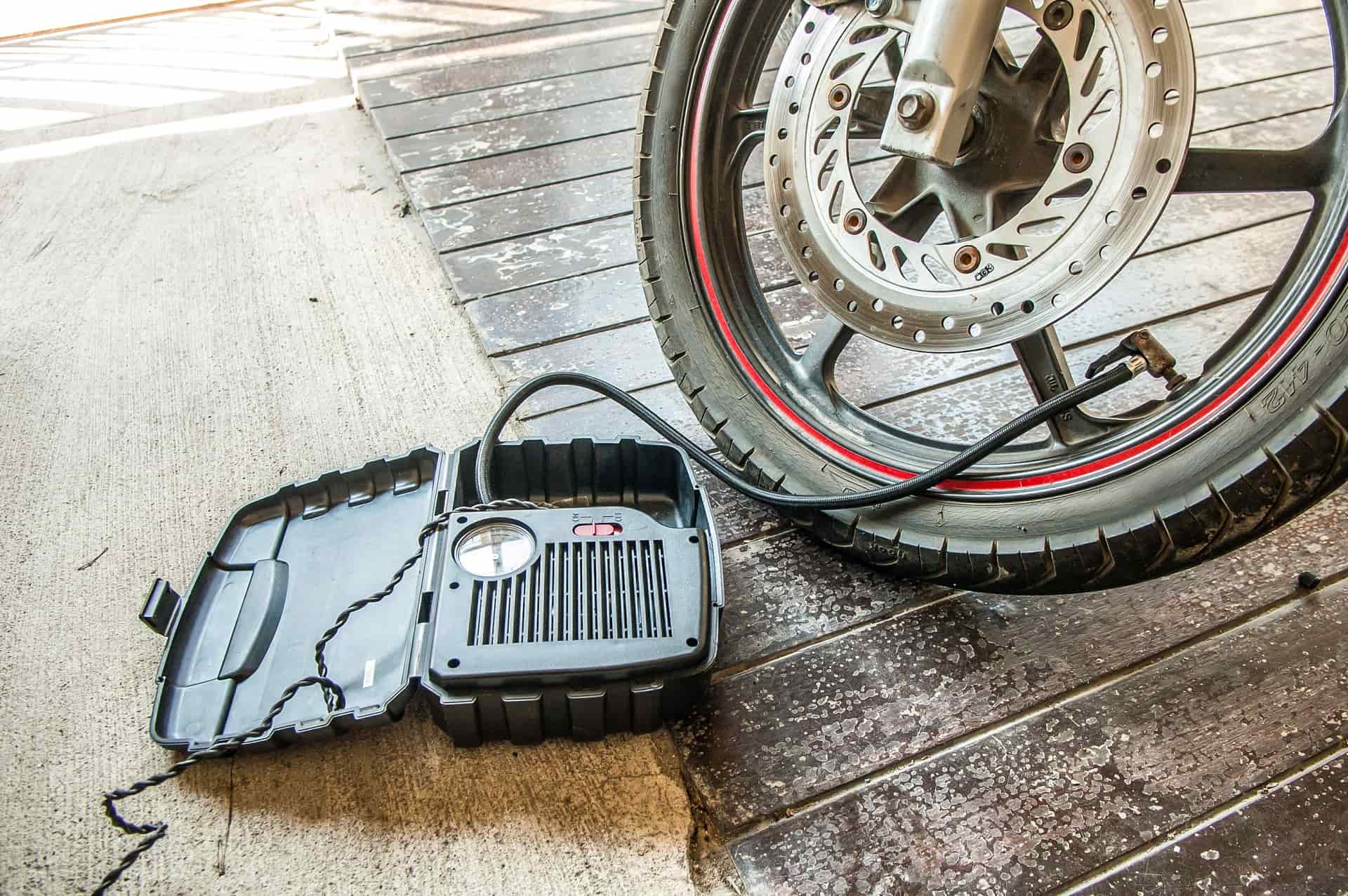 A portable tire inflator connected to a car tire valve