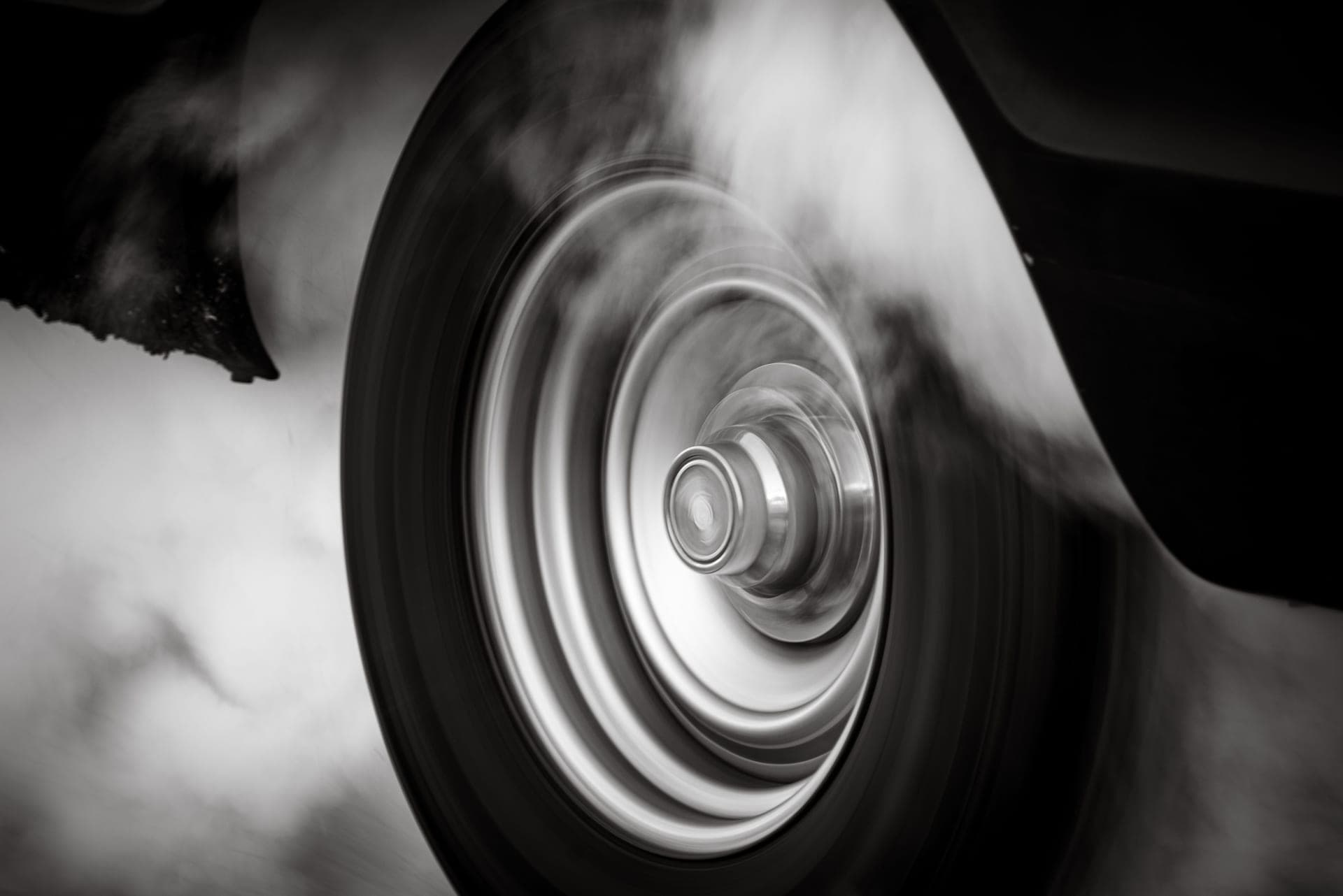 A car tire spinning in deep snow