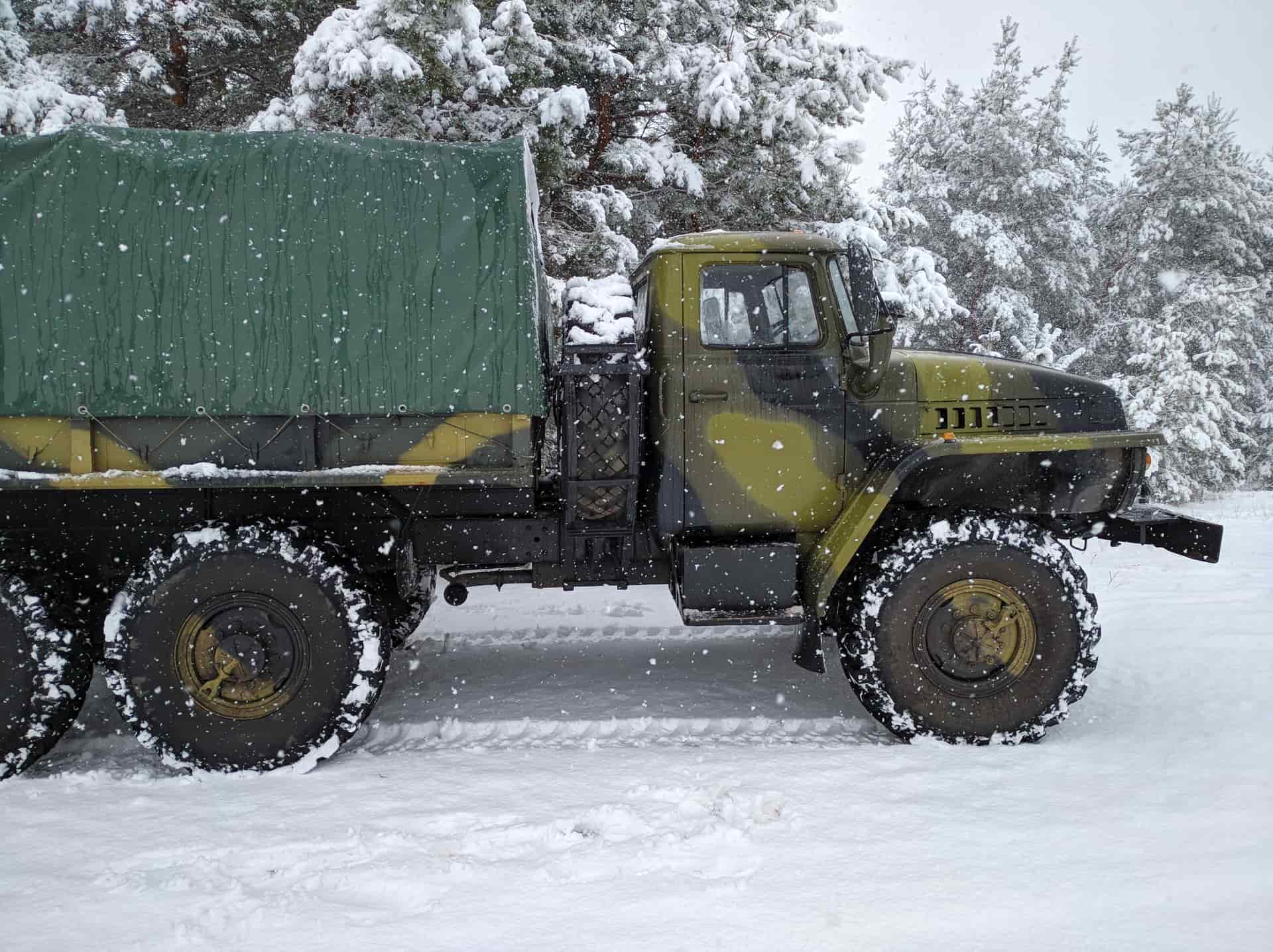 A truck on a snow-covered road in winter