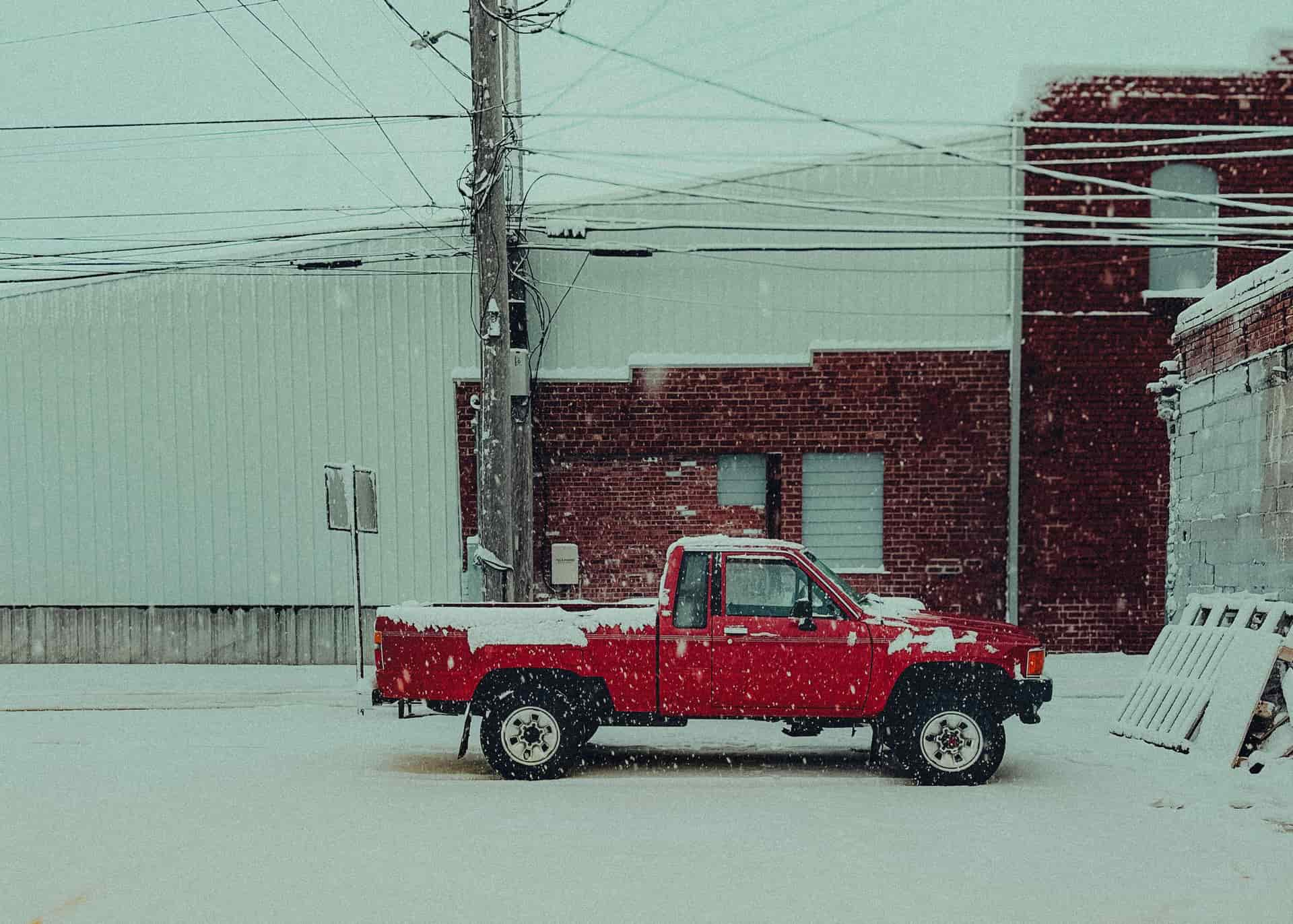 A pickup truck parked in winter snow