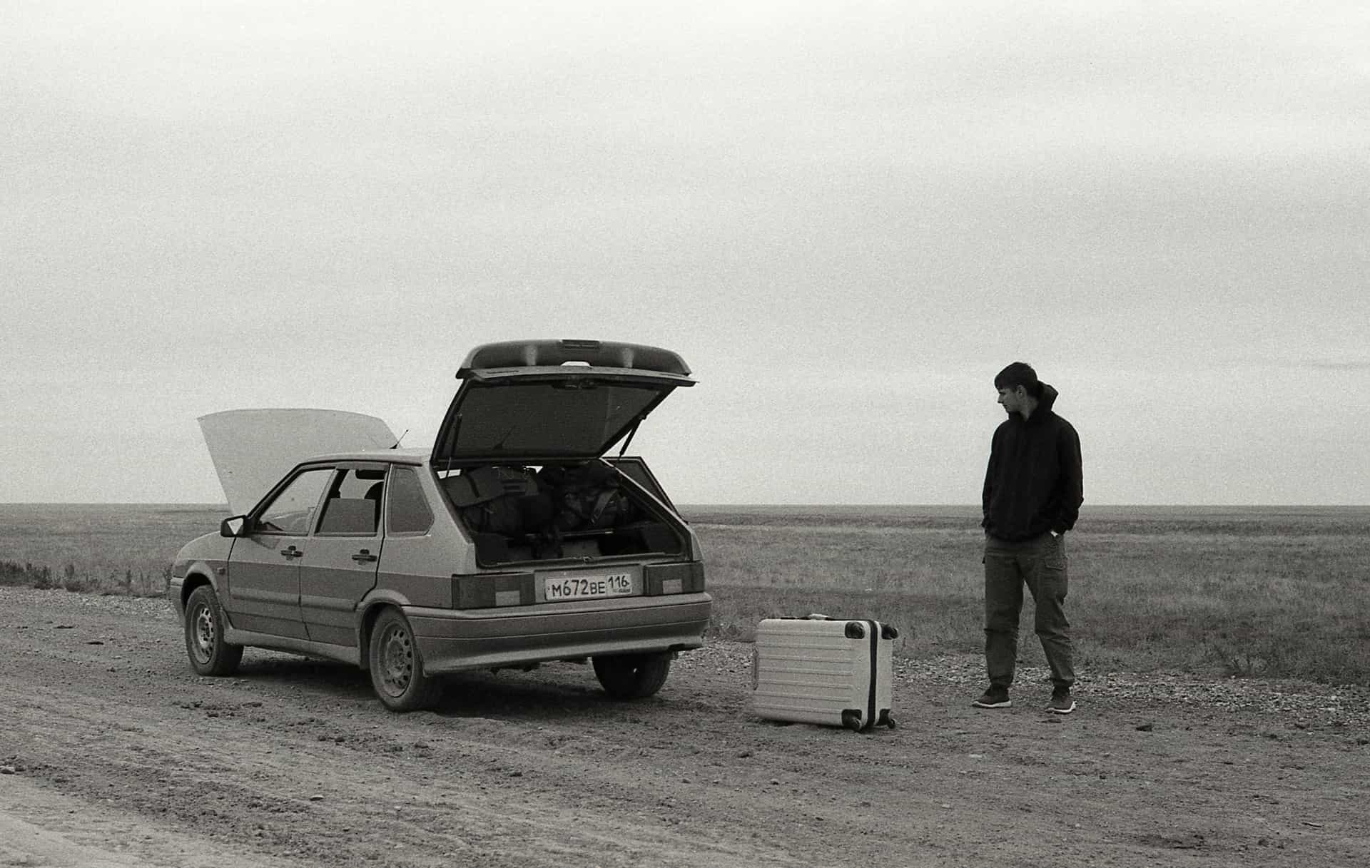 A vehicle stopped at the roadside with the trunk open