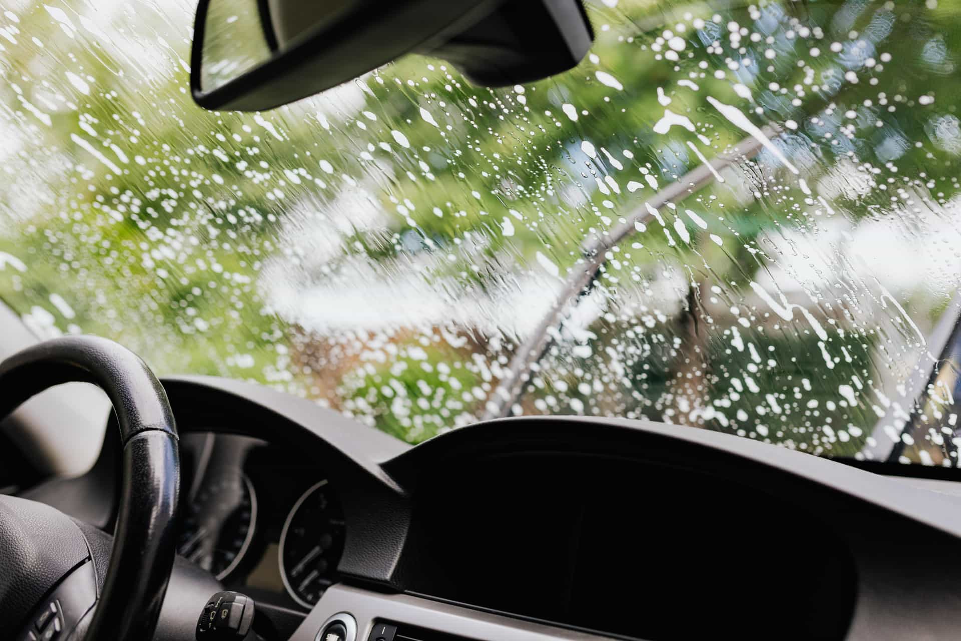 Washer fluid spraying across a car windshield