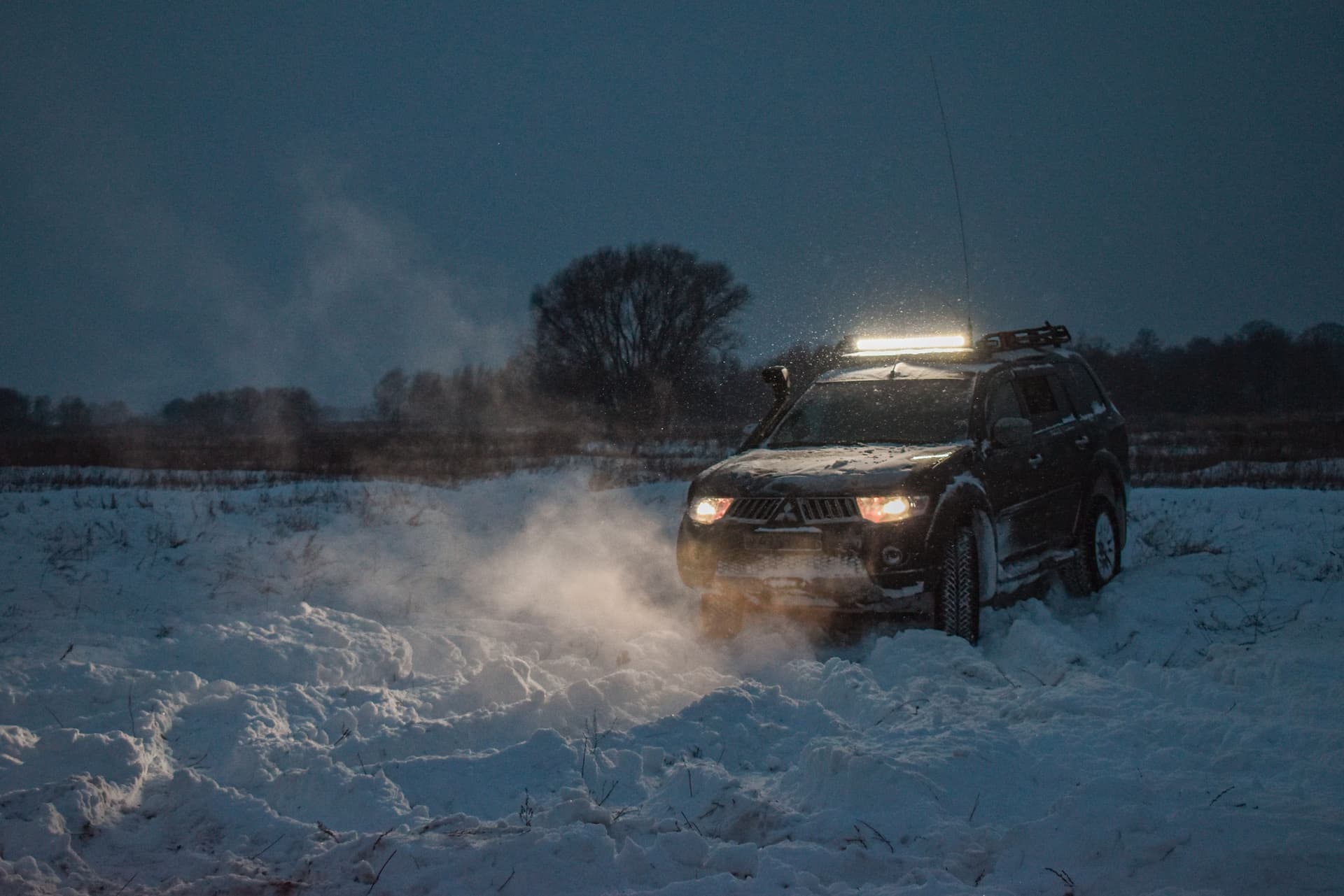 A car stuck in deep snow at the side of a road