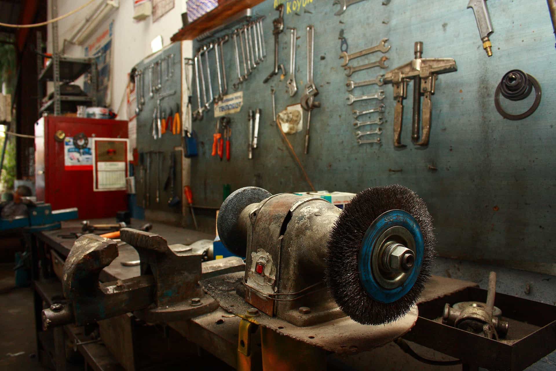Hand tools laid out on a workbench in cold light