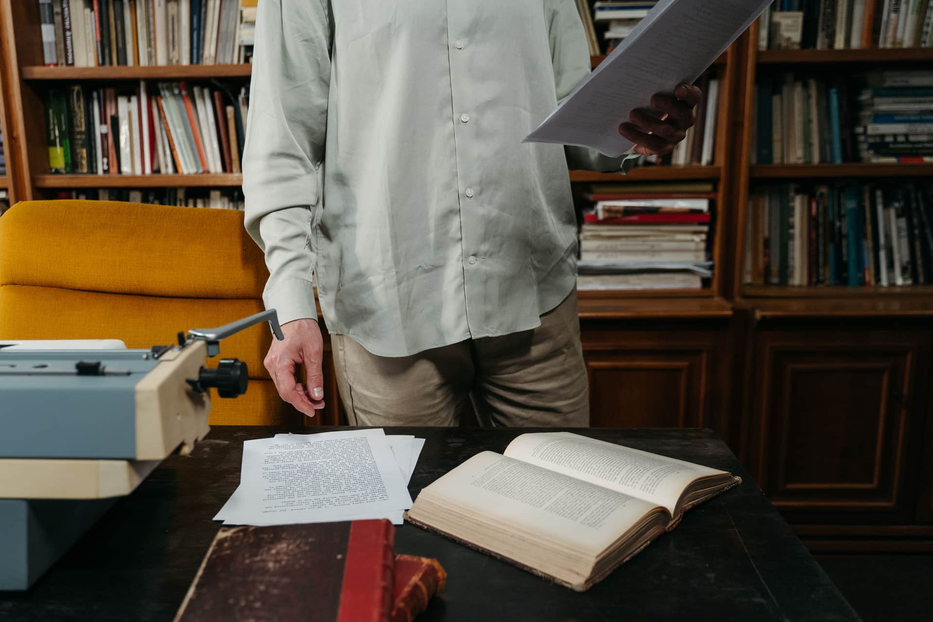 Someone reviewing printed documents at a table